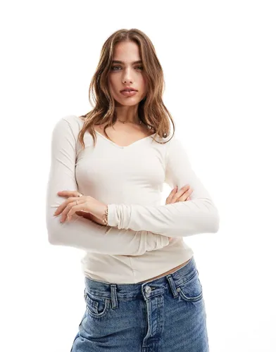 & Other Stories long sleeve v neck detail neck top in White/beige