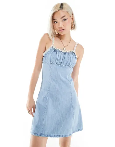 ASOS DESIGN denim mini cami dress with ruched bust and crochet strap detail in mid wash blue