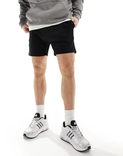 ASOS DESIGN shorter length skinny shorts in black