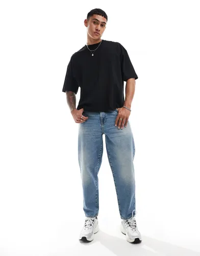 ASOS DESIGN tapered jeans in light wash blue