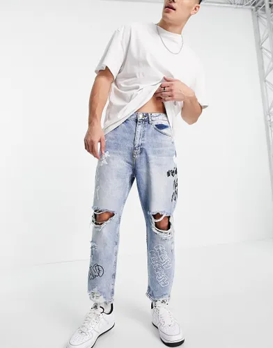 Bershka loose fit jeans with rips in mid blue