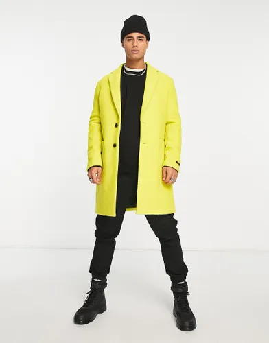Devils Advocate longline coat in yellow