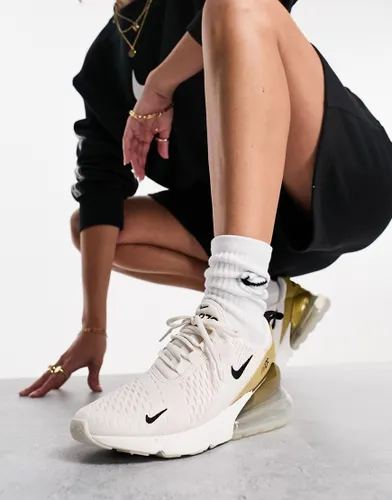 Nike Air Max 270 trainers in white and gold