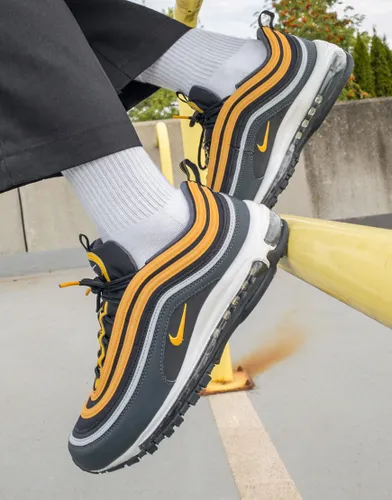 Nike Air Max 97 trainers in black and university gold