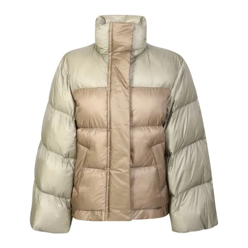 Sacai , Down jacket with wide sleeve detail by Sacai. The brand has been described as influential in breaking down the dichotomy between casual and fo