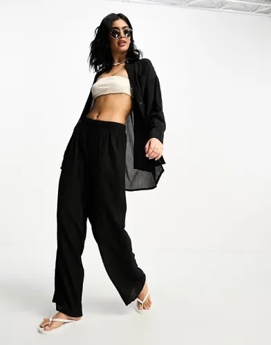 The Frolic tourmaline shirred wide long trouser co-ord in black pleated texture