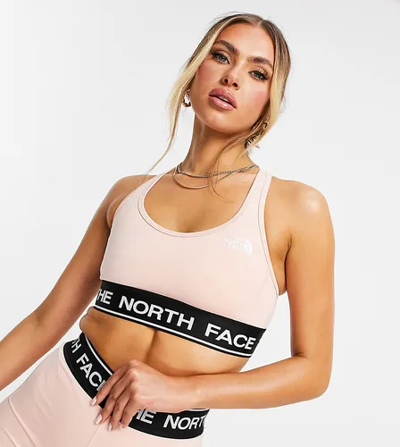 The North Face Tech sports bra in light pink Exclusive at ASOS