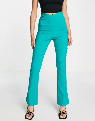 Vesper dipped waist flared trousers in turquoise-Green